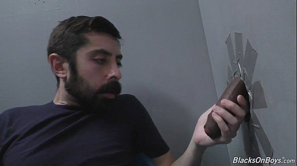Bearded white man sucking and fucking a black cock at a gloryhole - 2