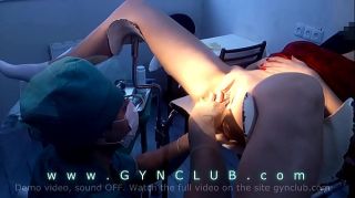 XBizShow girl in red on a gynecological chair XBizShow