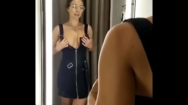 Girl changes clothes in fitting room. - 2